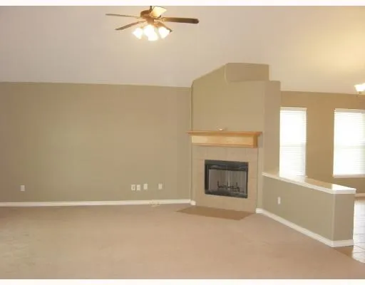 a living room with a fireplace and a window