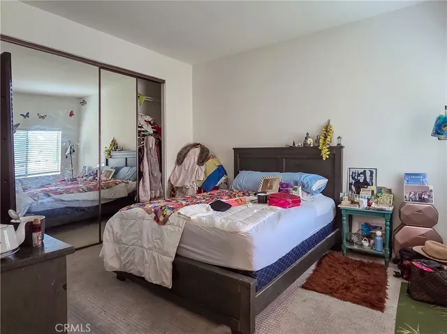 a bedroom with bed and a chandelier