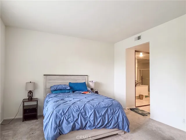 a bedroom with a bed and a lamp with window