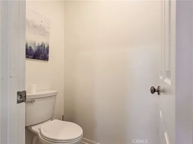 a white toilet sitting next to a shower