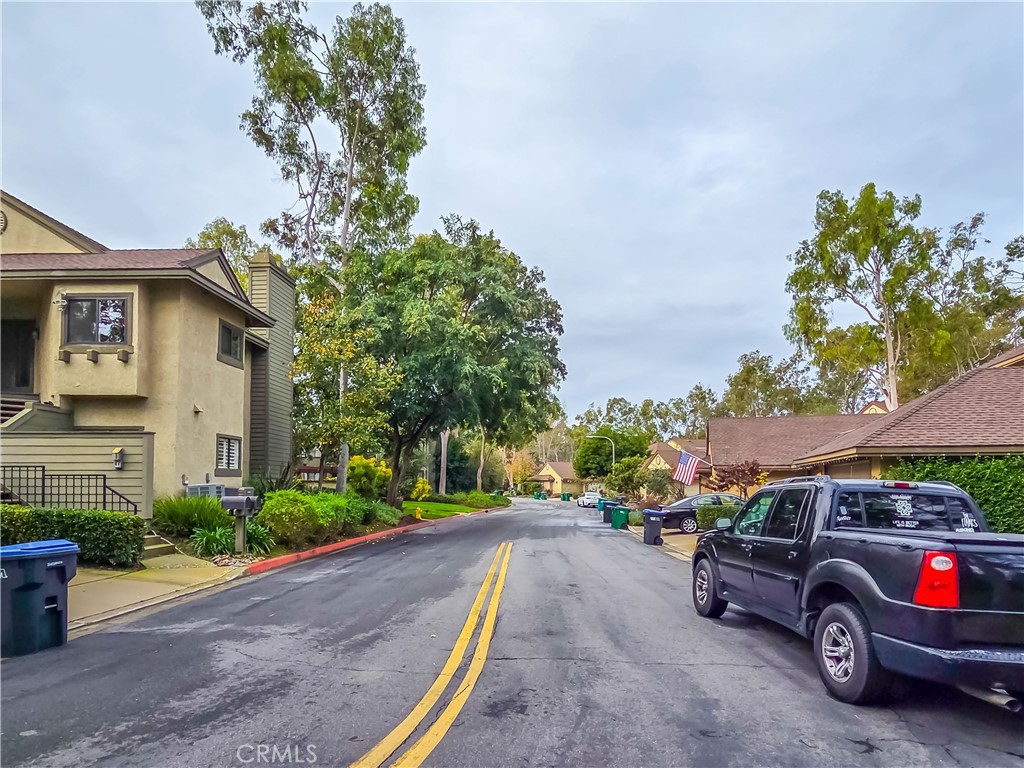 59 Rainbow Ridge Irvine, CA 92603 - Photo 28 of 35 a front view of a house with a garden and parking