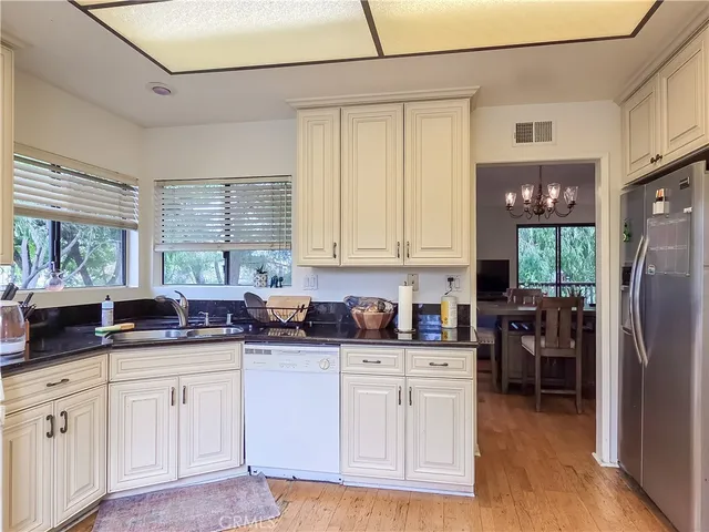 a kitchen with stainless steel appliances granite countertop a refrigerator sink and cabinets