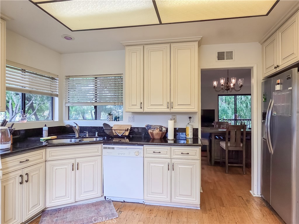59 Rainbow Ridge Irvine, CA 92603 - Photo 3 of 35 a kitchen with stainless steel appliances granite countertop a refrigerator sink and cabinets