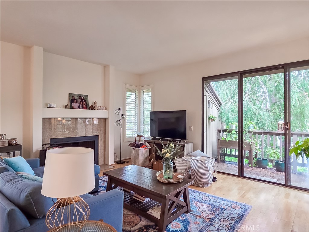 59 Rainbow Ridge Irvine, CA 92603 - Photo 7 of 35 a living room with furniture a fireplace and a flat screen tv