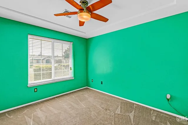 a view of a room with window and ceiling fan