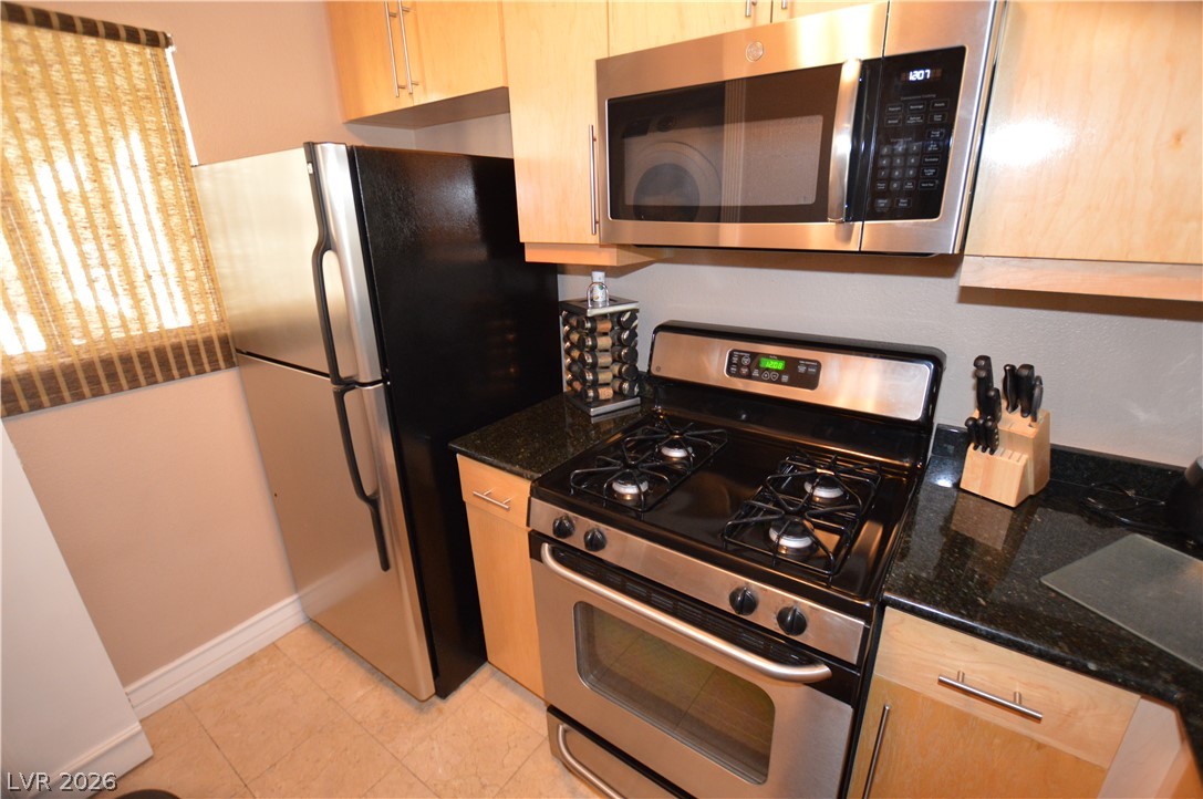 220 East Flamingo Road, Unit 327 Las Vegas, NV 89169 - Photo 7 of 13 Functional kitchen with ample cabinet space, granite countertops, and modern stainless steel appliances.