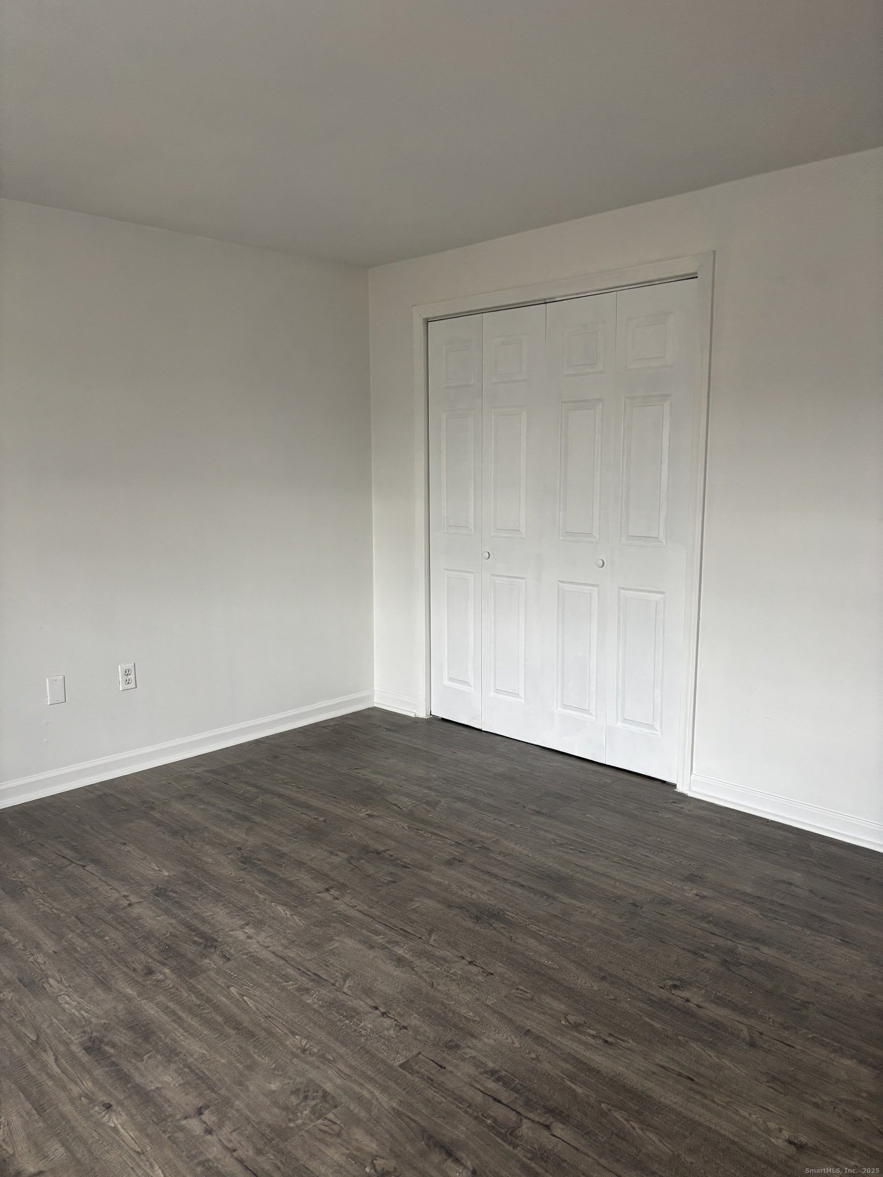 49 Grandview Drive, Unit A Farmington, CT 06032 - Photo 12 of 18 a view of an empty room with wooden floor