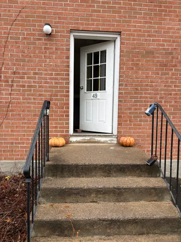 a view of a house with a door and wooden floor