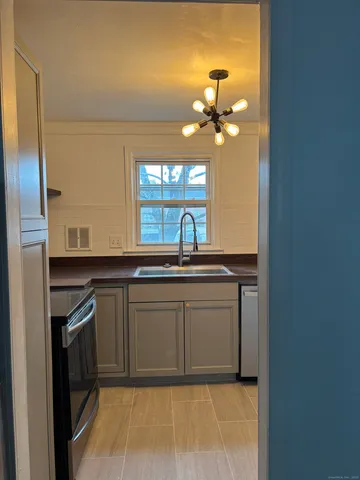 a kitchen with a sink and a refrigerator