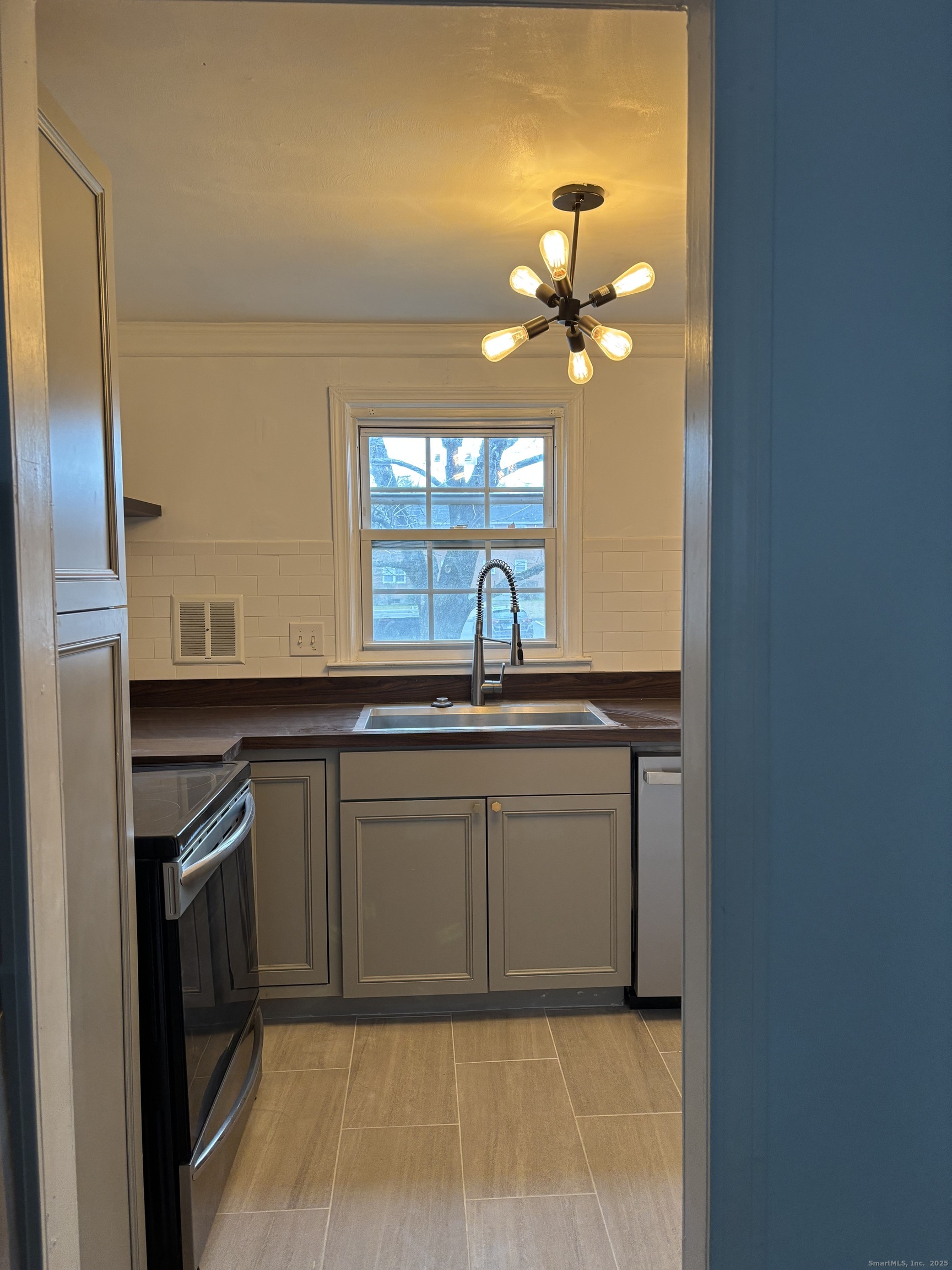 49 Grandview Drive, Unit A Farmington, CT 06032 - Photo 2 of 18 a kitchen with a sink and a refrigerator