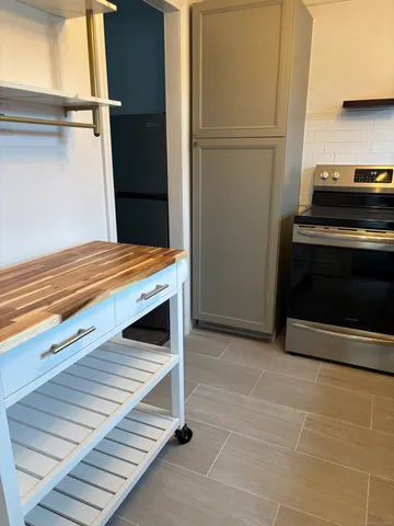 a kitchen with a refrigerator and a stove