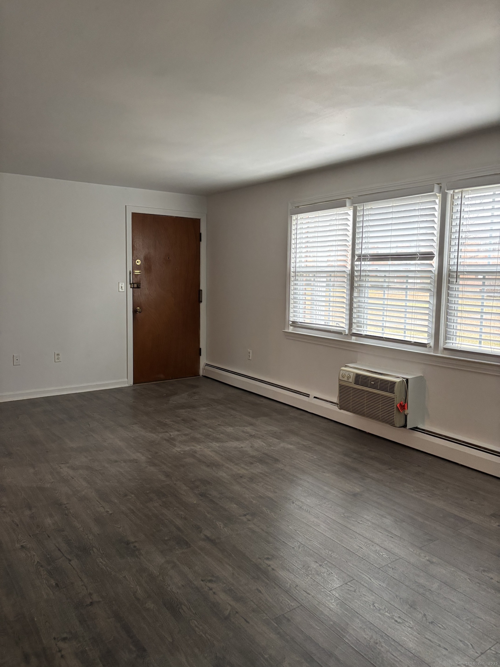 49 Grandview Drive, Unit A Farmington, CT 06032 - Photo 9 of 18 an empty room with wooden floor and windows