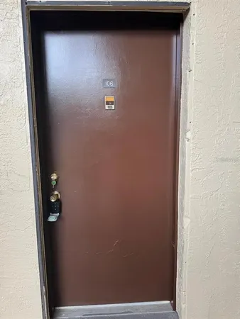 a living room with a couch and a ceiling fan