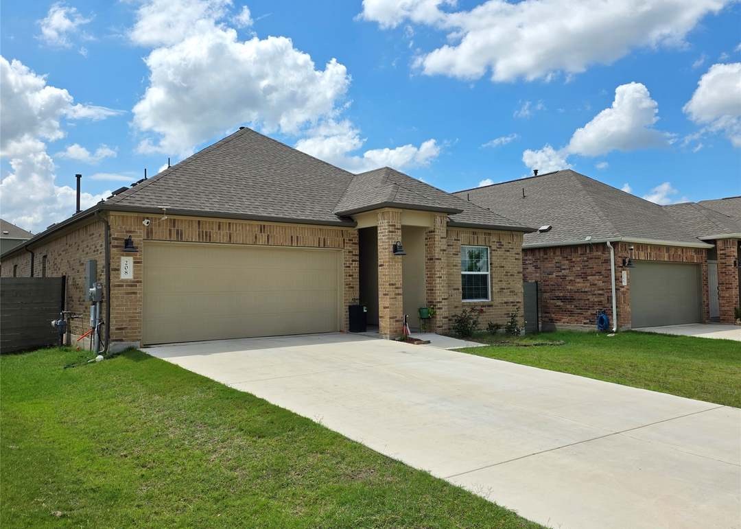 208 Wolf Springs Road Georgetown, TX 78628 - Photo 1 of 32 A classic brick exterior with a welcoming porch and well-maintained lawn.