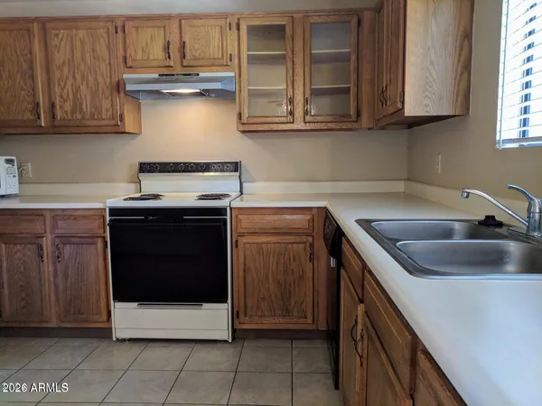 a kitchen with stainless steel appliances granite countertop a sink and a stove