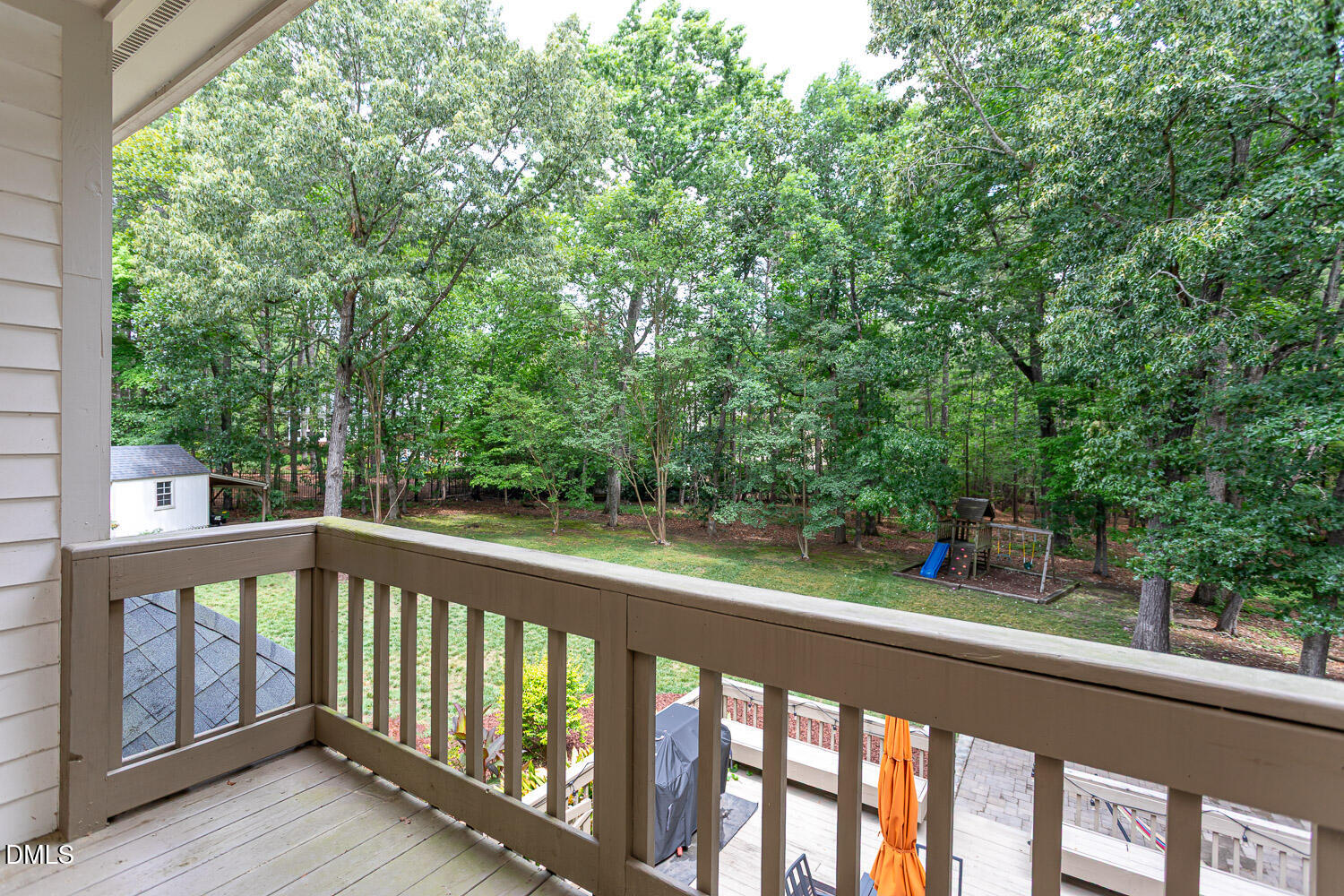 8509 Towneley Place Raleigh, NC 27615 - Photo 17 of 36 a view of a wooden deck next to a yard