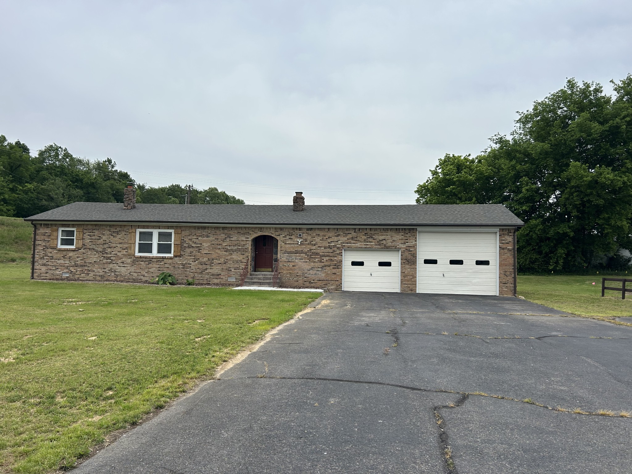 20 Ball Park Road Big Sandy, TN 38221 - Photo 1 of 33 a front view of a house with garden