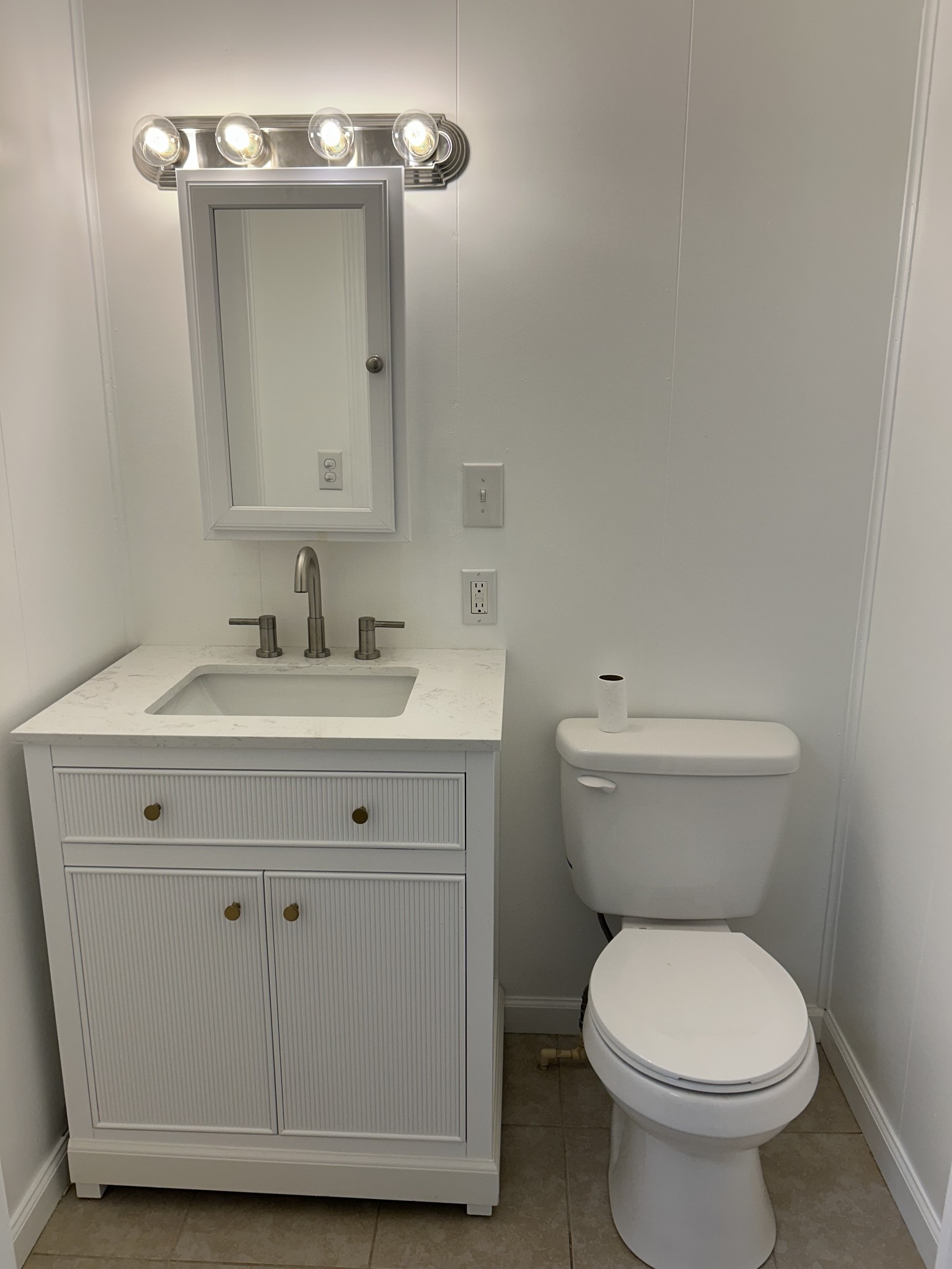 20 Ball Park Road Big Sandy, TN 38221 - Photo 15 of 33 a bathroom with a toilet sink and mirror