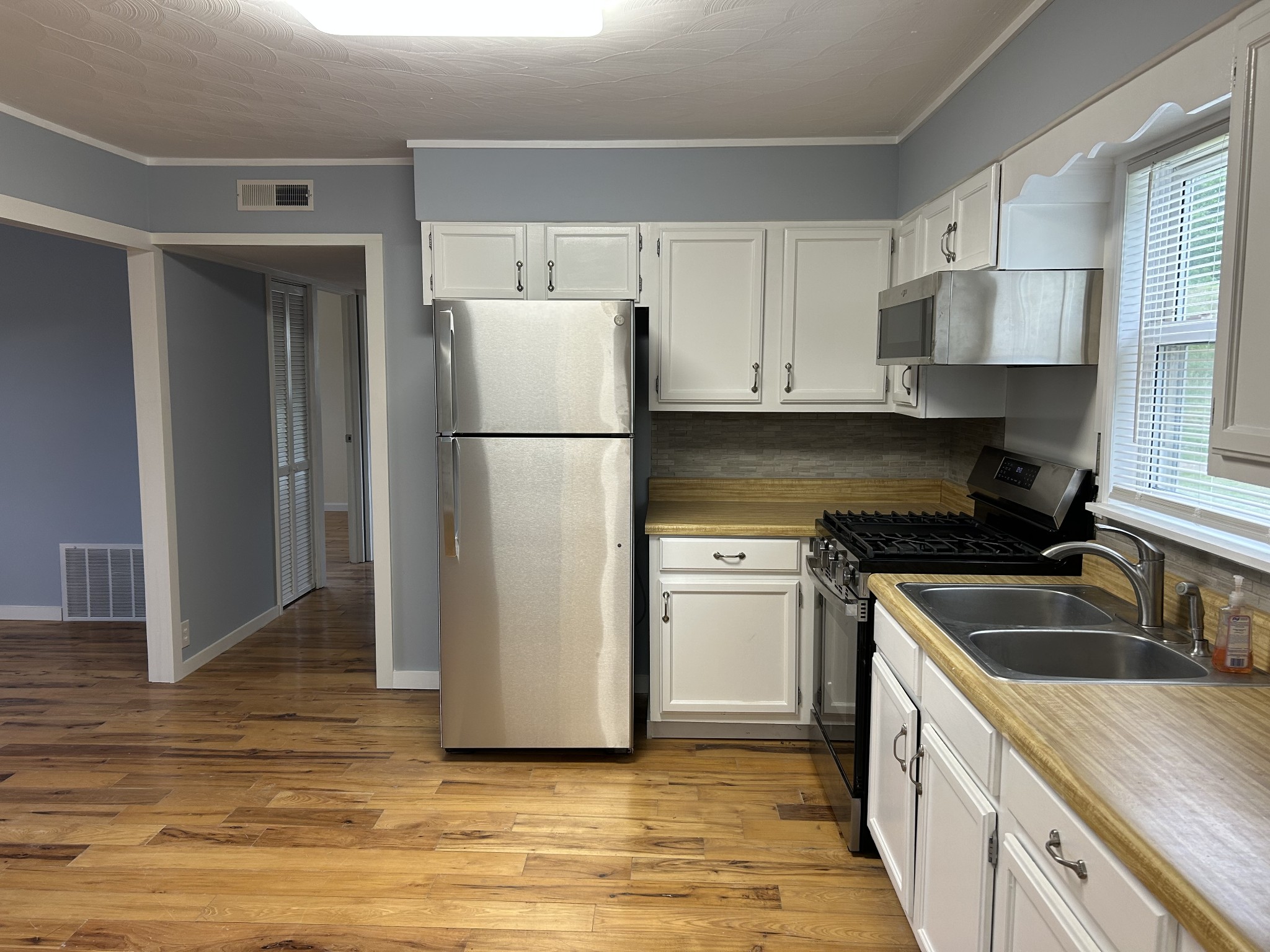 20 Ball Park Road Big Sandy, TN 38221 - Photo 16 of 33 a kitchen with a refrigerator sink and cabinets