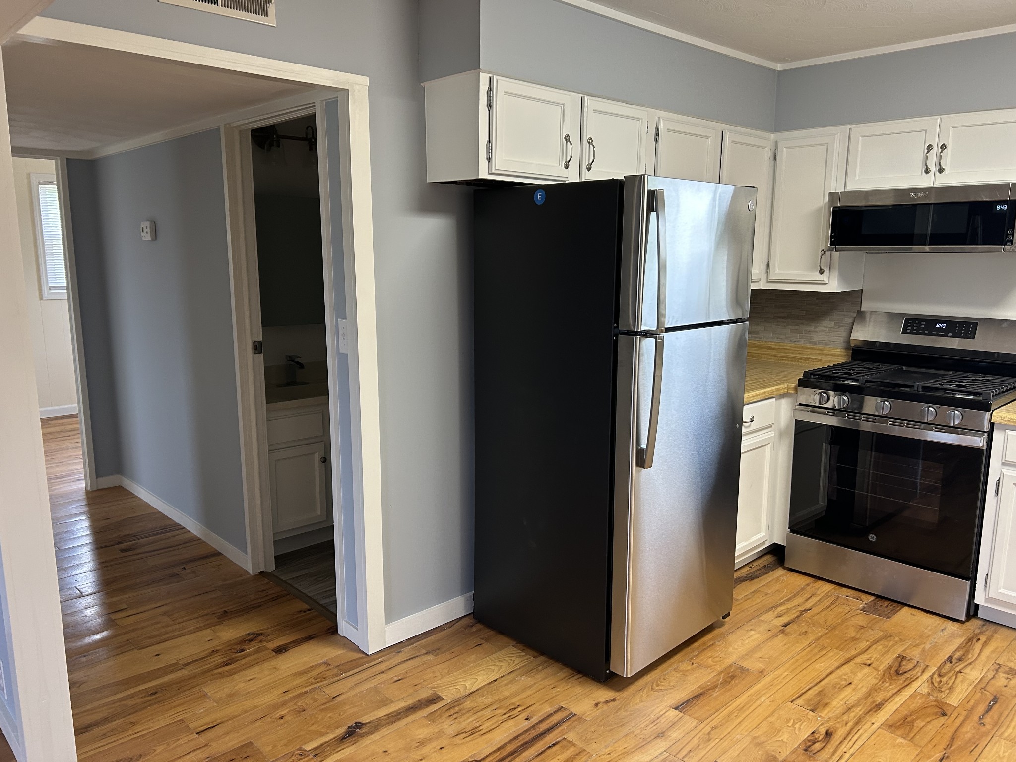 20 Ball Park Road Big Sandy, TN 38221 - Photo 19 of 33 a kitchen with a refrigerator stove and wooden cabinets