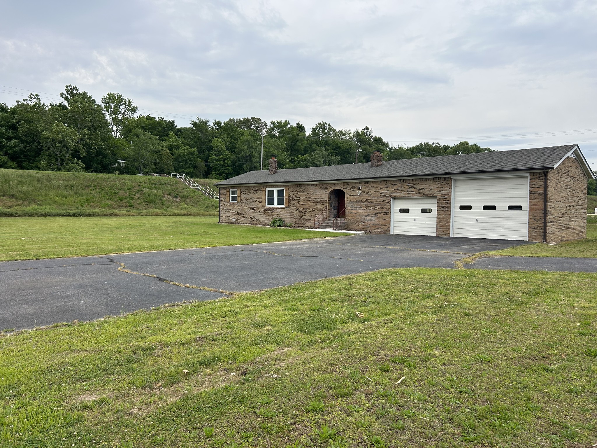 20 Ball Park Road Big Sandy, TN 38221 - Photo 29 of 33 a house view with a garden space