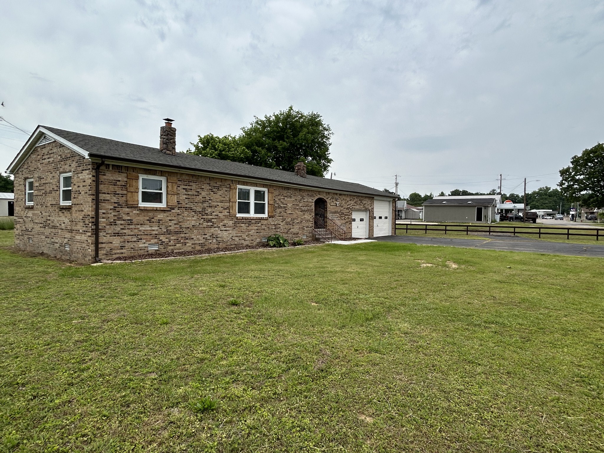 20 Ball Park Road Big Sandy, TN 38221 - Photo 8 of 33 a front view of house with yard and outdoor seating