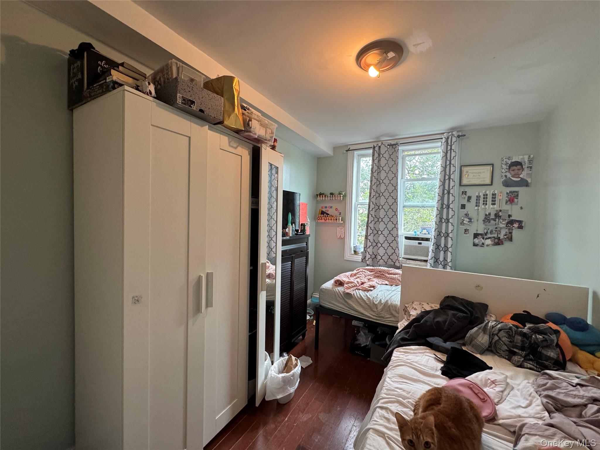 101-20 39th Avenue Queens, NY 11368 - Photo 12 of 17 a bed room with a bed and a window