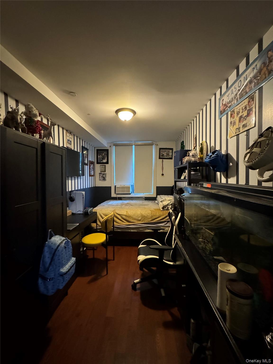 101-20 39th Avenue Queens, NY 11368 - Photo 6 of 17 a room with furniture a air conditioner and a window