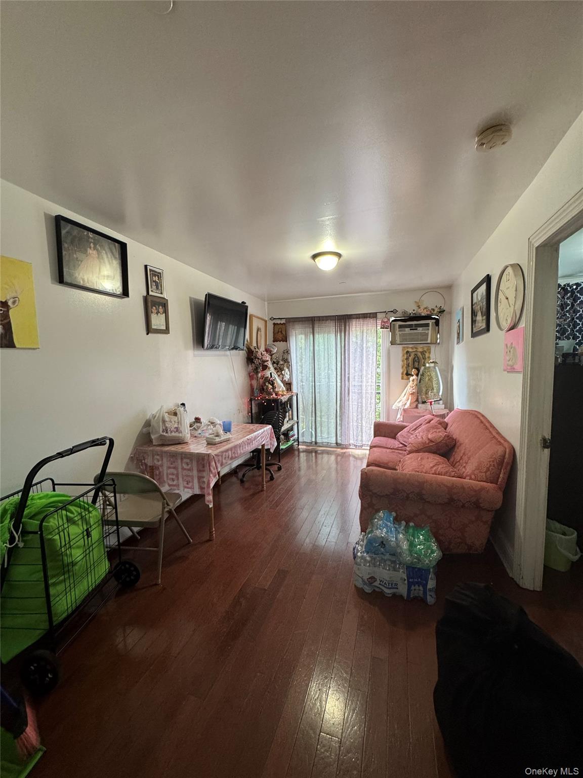 101-20 39th Avenue Queens, NY 11368 - Photo 9 of 17 a living room with furniture and a table