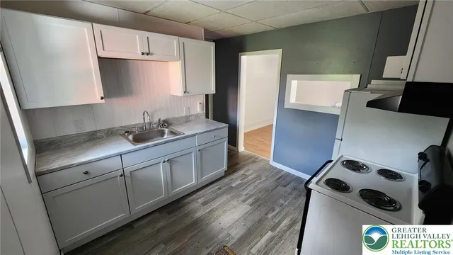 a kitchen with stainless steel appliances a sink a stove and a refrigerator