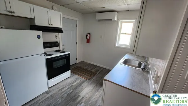 a kitchen with a refrigerator and a sink
