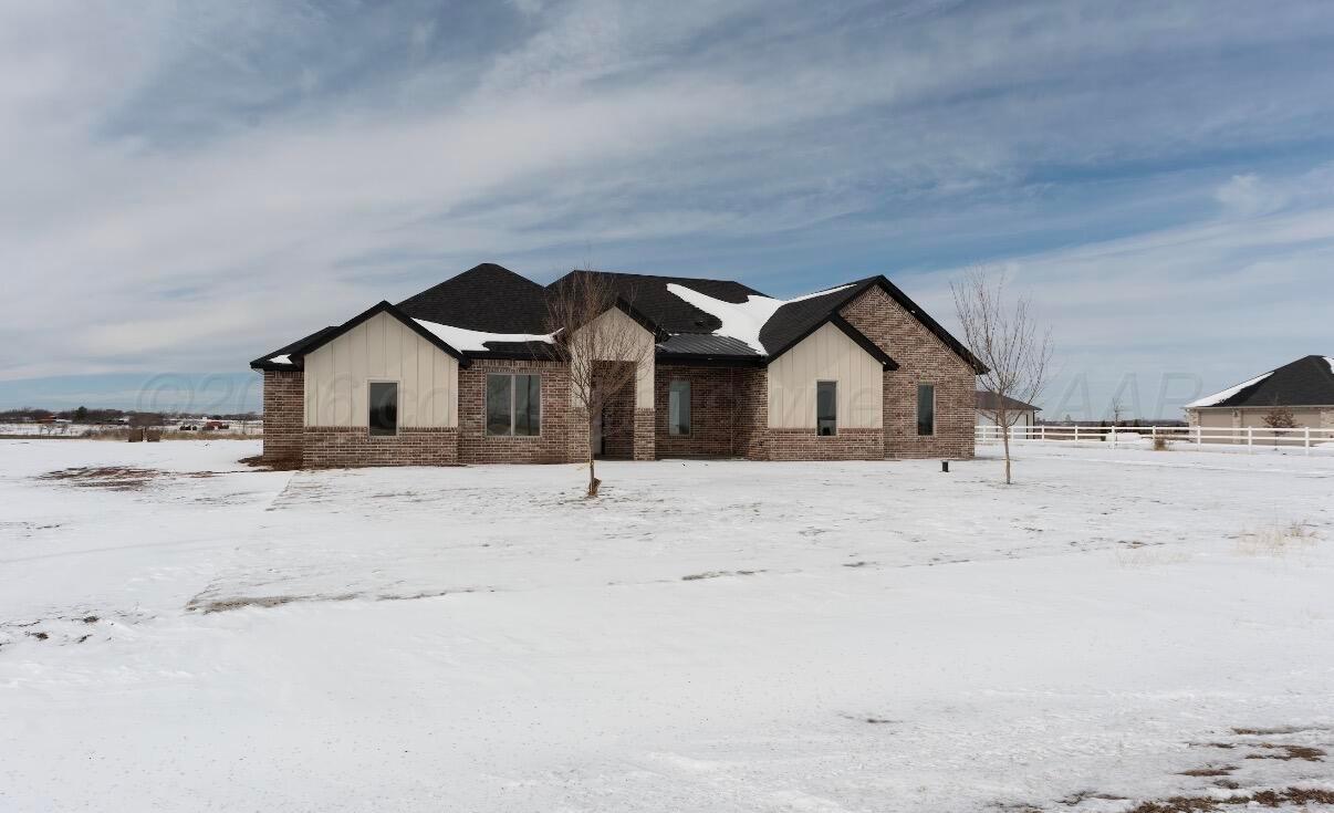 a view of white house with wooden fence