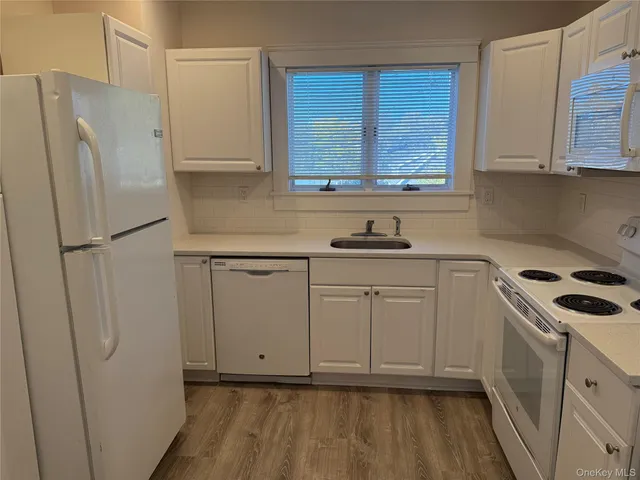 a kitchen with stainless steel appliances a refrigerator sink and cabinets