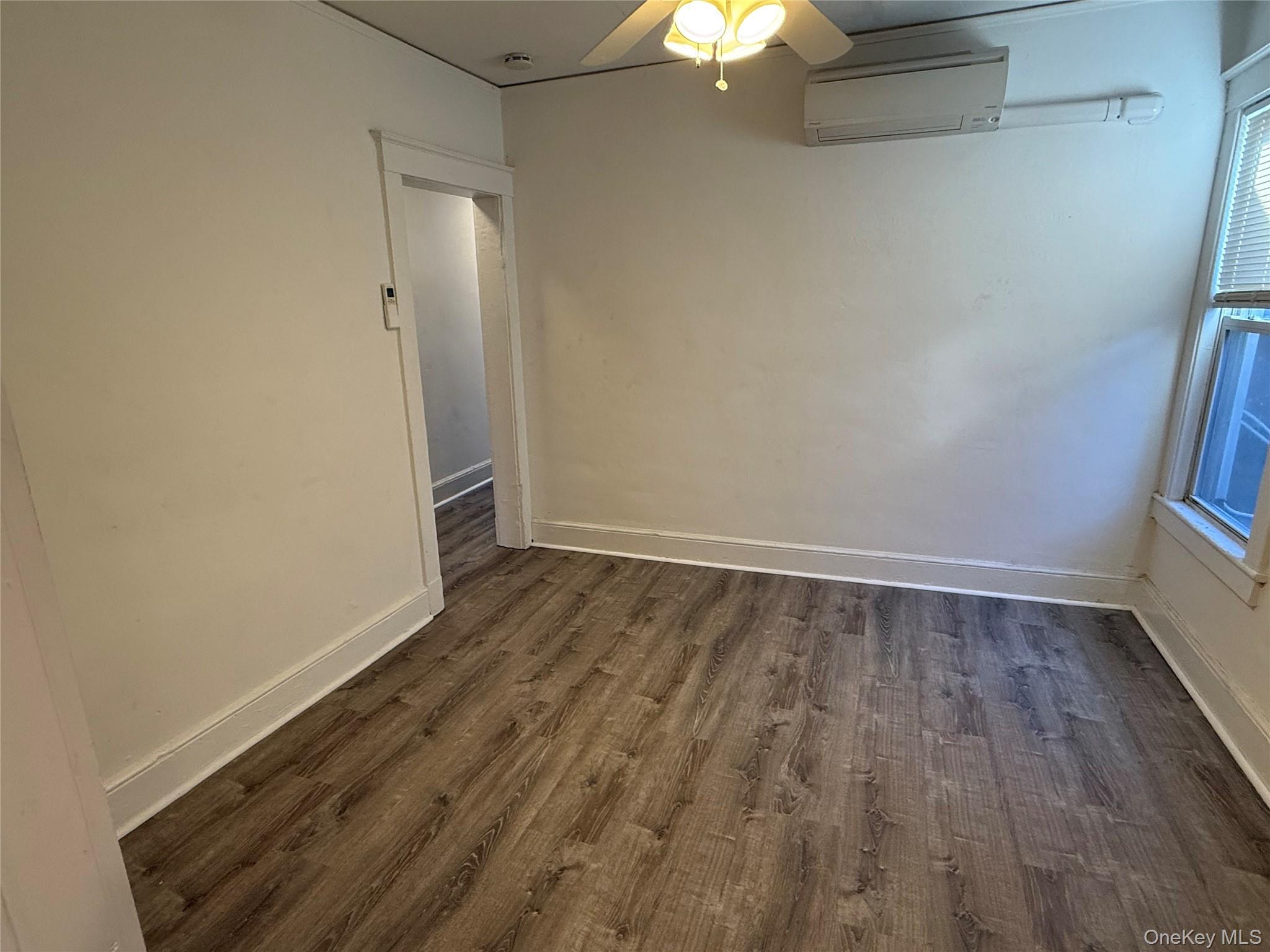 593 Main Street, Unit A Islip, NY 11751 - Photo 2 of 5 a view of an empty room with wooden floor and a window