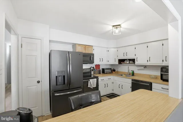 a kitchen with stainless steel appliances a refrigerator sink and cabinets