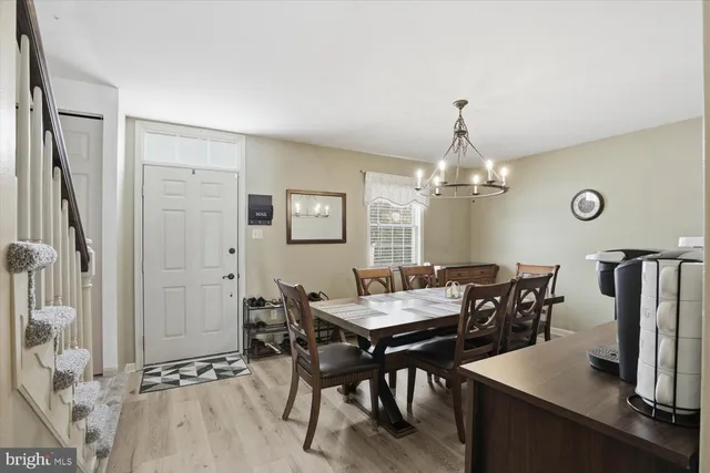 a view of a dining room with furniture and a chandelier