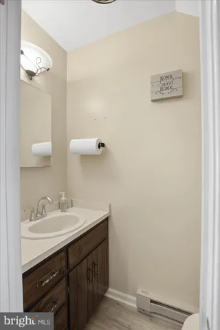 a bathroom with a sink vanity and a mirror