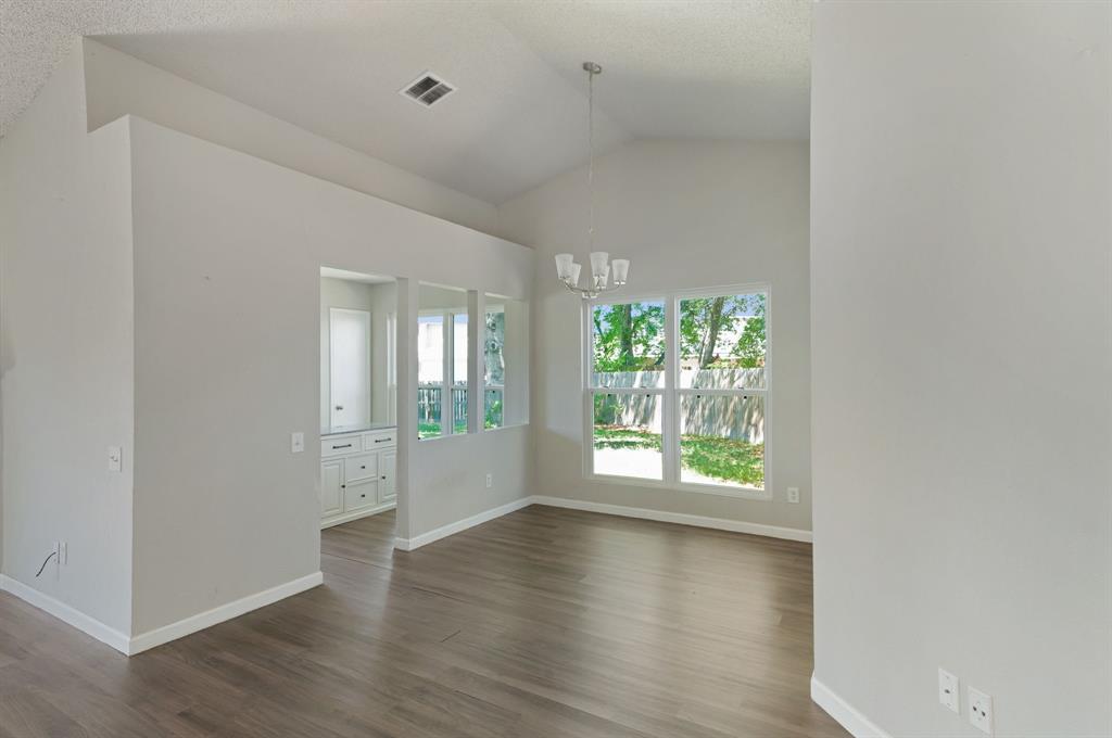 1019 Danforth Court Arlington, TX 76017 - Photo 12 of 37 an empty room with wooden floor and windows