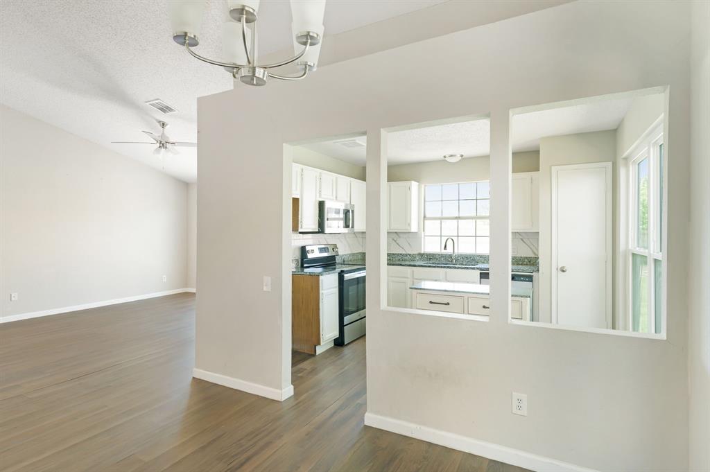 1019 Danforth Court Arlington, TX 76017 - Photo 13 of 37 a kitchen with stainless steel appliances a refrigerator a sink dishwasher a stove and white cabinets with wooden floor