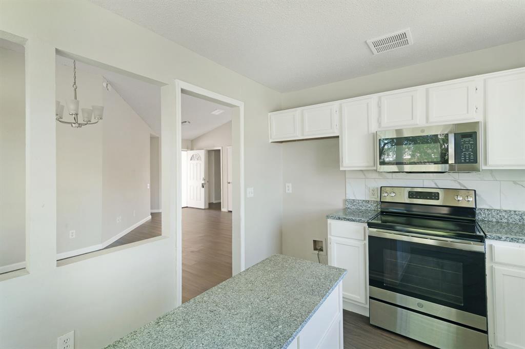 1019 Danforth Court Arlington, TX 76017 - Photo 15 of 37 a kitchen with a stove and a microwave