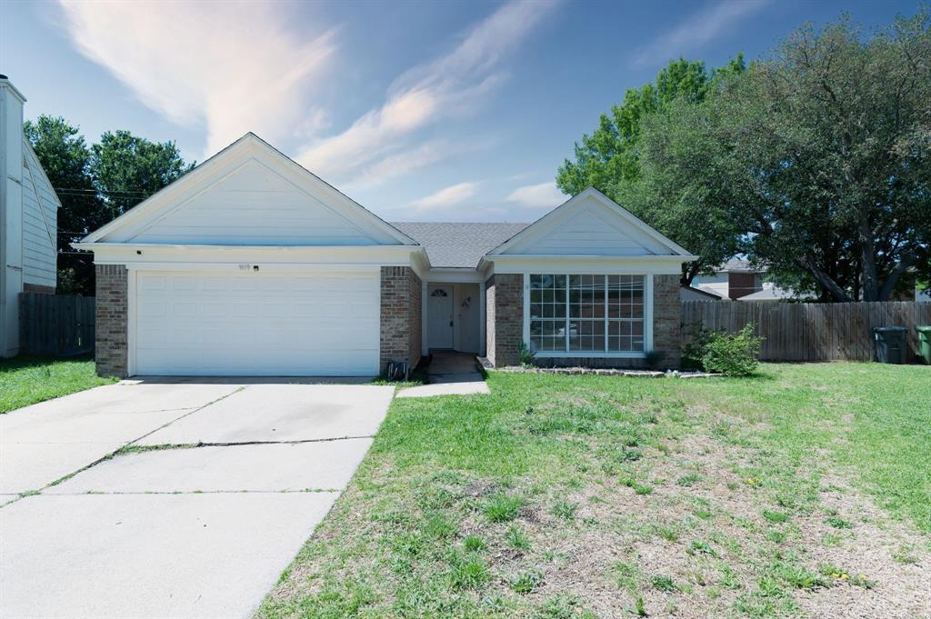 1019 Danforth Court Arlington, TX 76017 - Photo 2 of 37 a front view of a house with a yard and garage