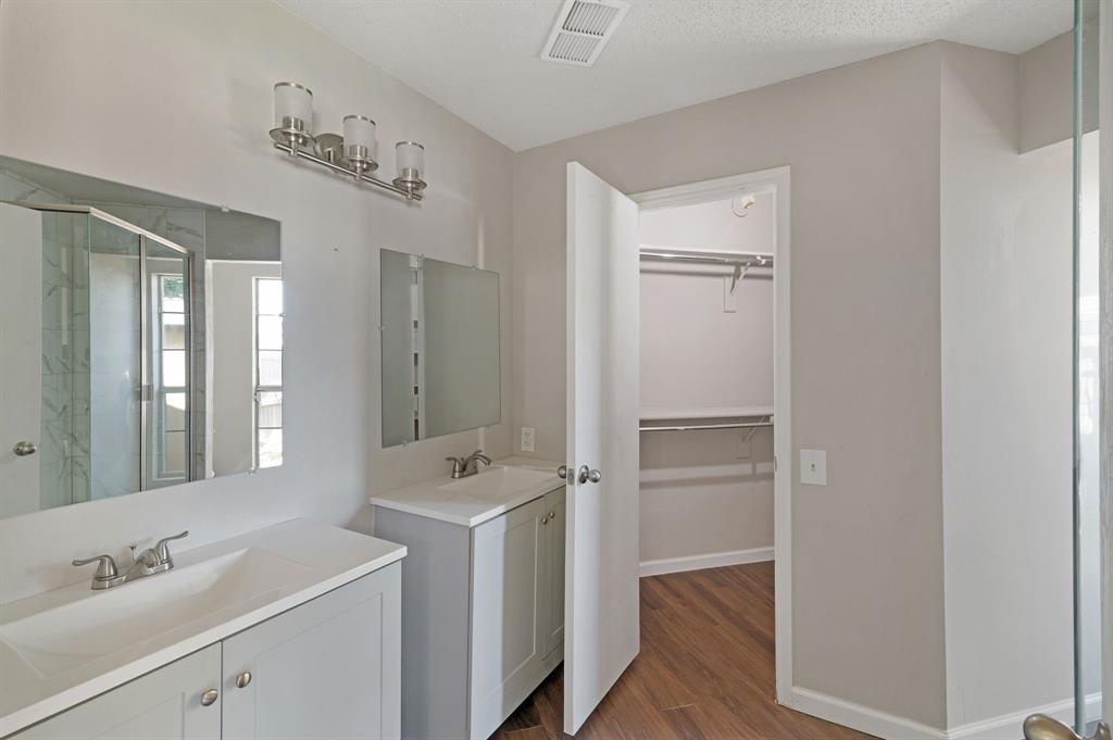 1019 Danforth Court Arlington, TX 76017 - Photo 22 of 37 a bathroom with a sink a shower and a mirror