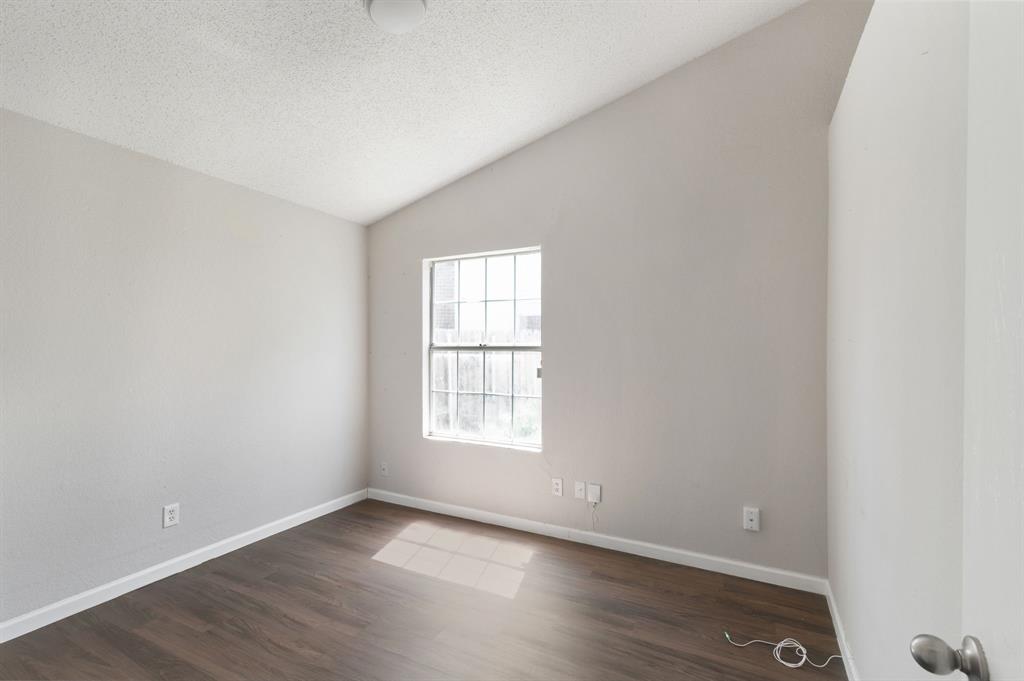 1019 Danforth Court Arlington, TX 76017 - Photo 27 of 37 an empty room with wooden floor and windows