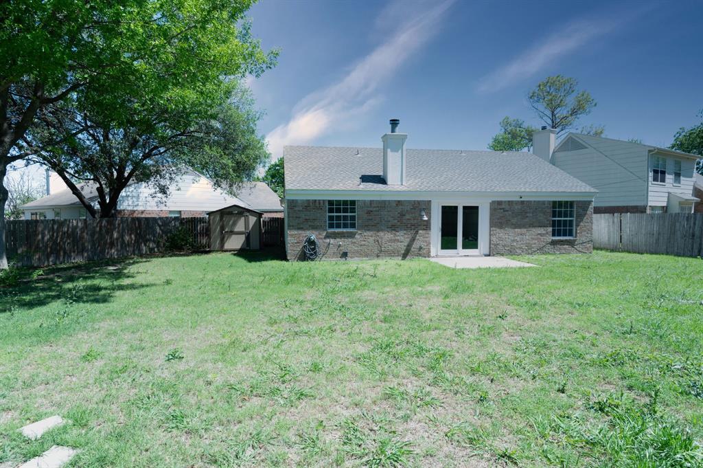 1019 Danforth Court Arlington, TX 76017 - Photo 36 of 37 a front view of a house with a yard and garage