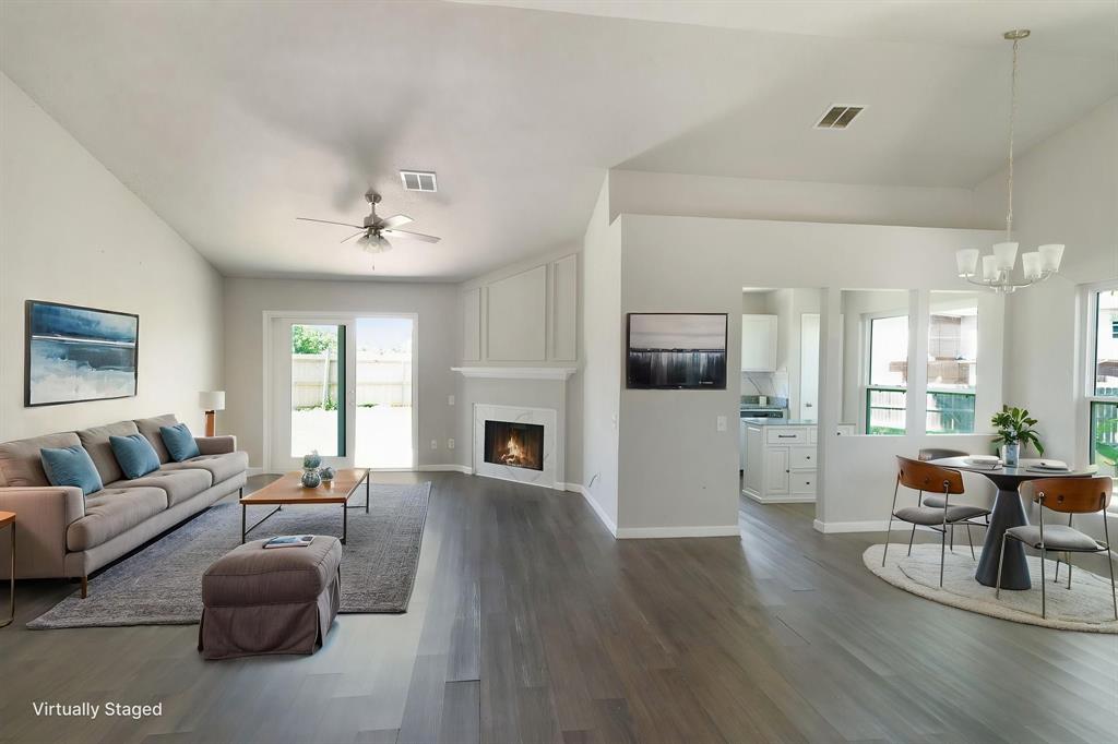 1019 Danforth Court Arlington, TX 76017 - Photo 4 of 37 a living room with furniture a fireplace and a flat screen tv