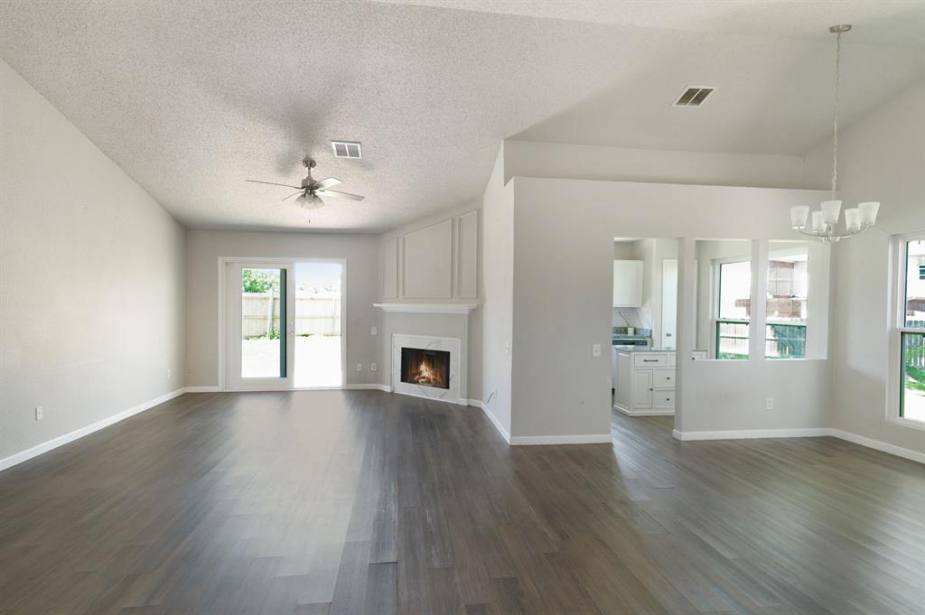 1019 Danforth Court Arlington, TX 76017 - Photo 5 of 37 a view of an empty room with wooden floor and a window
