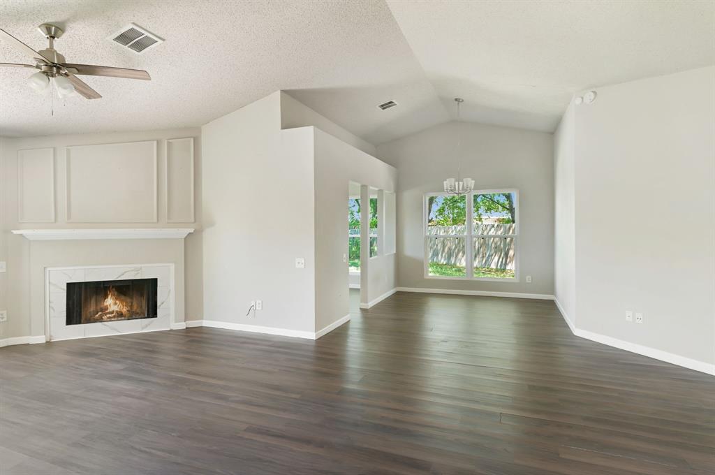 1019 Danforth Court Arlington, TX 76017 - Photo 7 of 37 a view of an empty room with window and wooden floor
