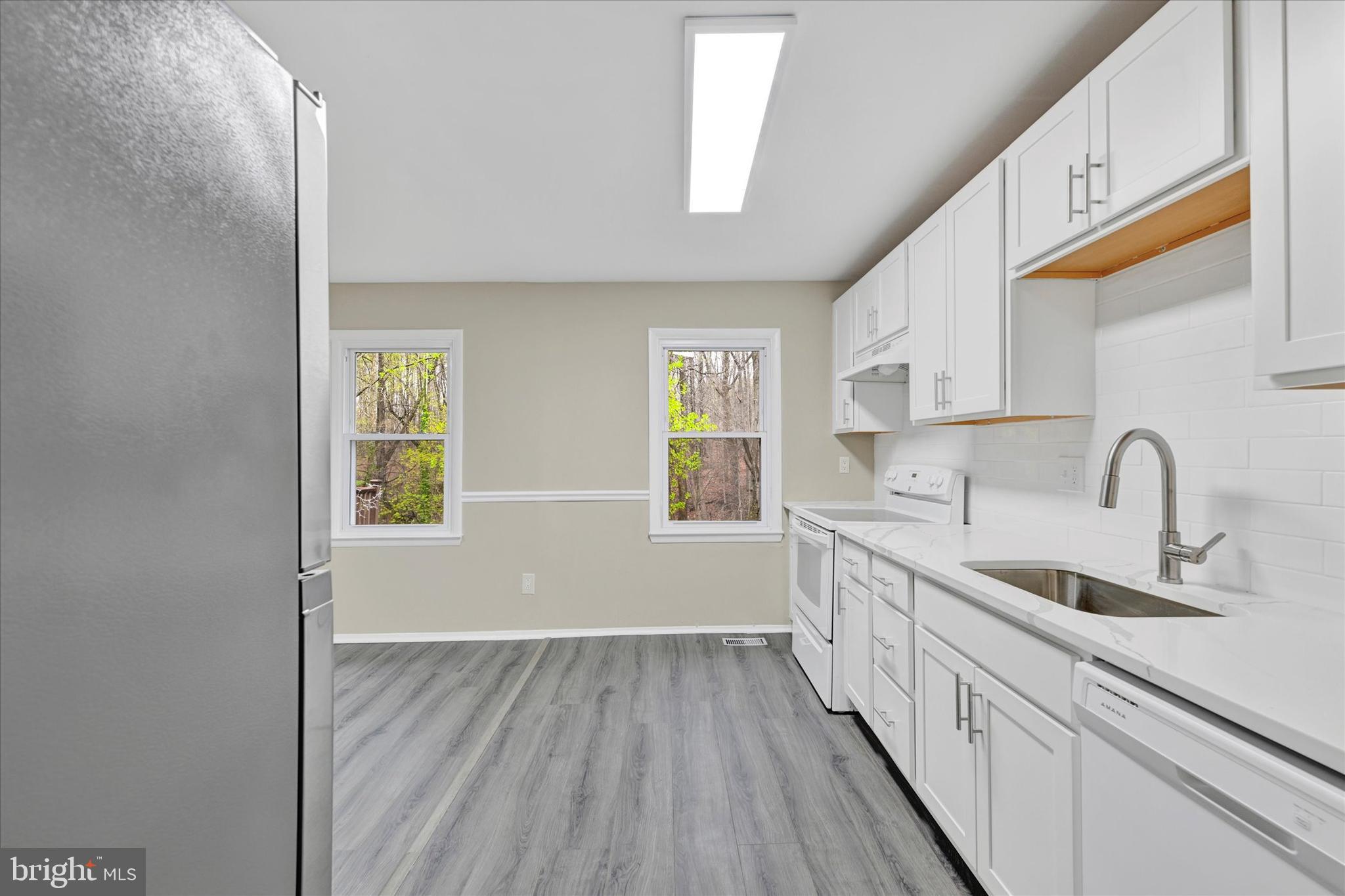 3447 Santee Road Baltimore, MD 21236 - Photo 13 of 32 a kitchen with a sink and wooden floor