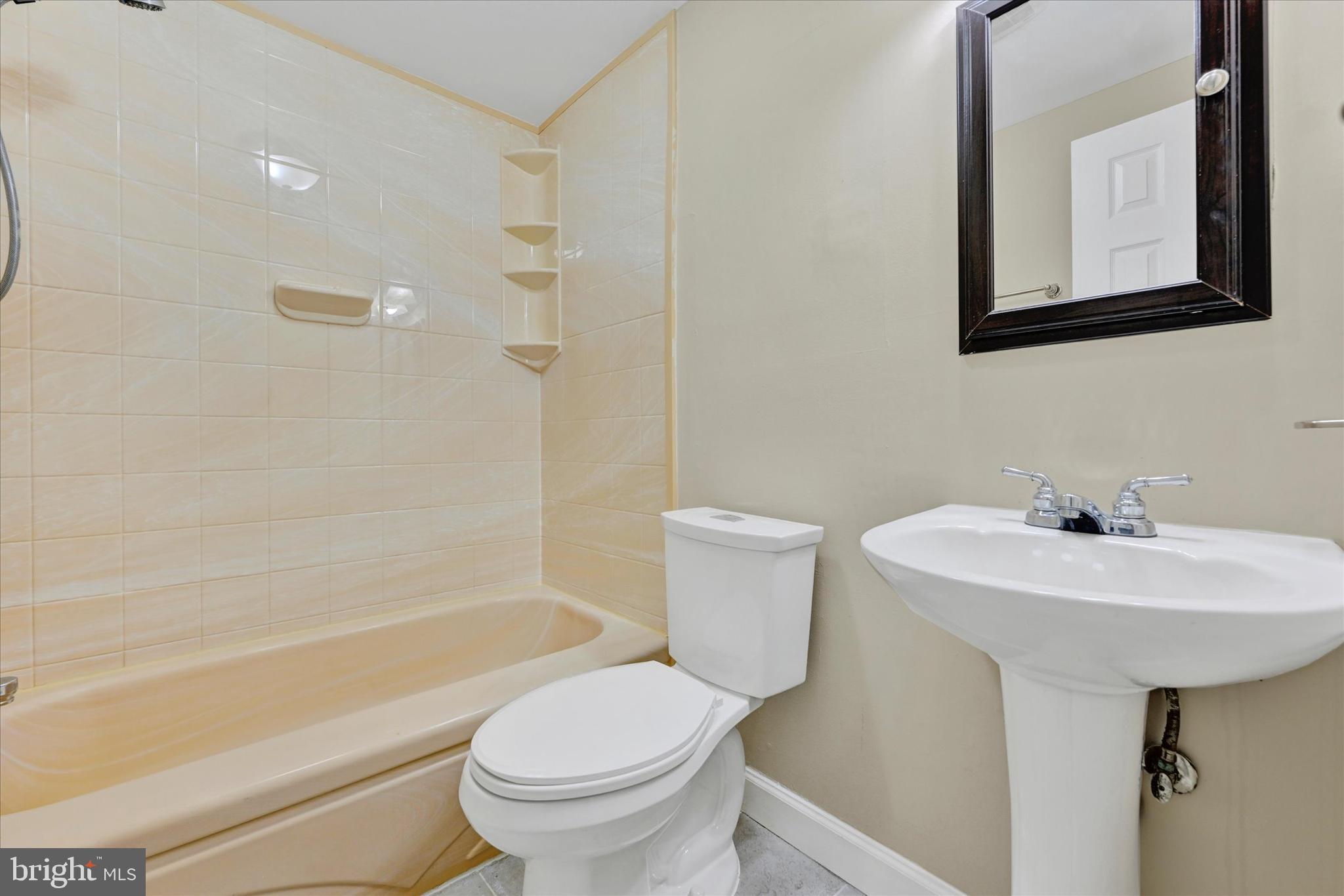 3447 Santee Road Baltimore, MD 21236 - Photo 17 of 32 a bathroom with a sink toilet and shower