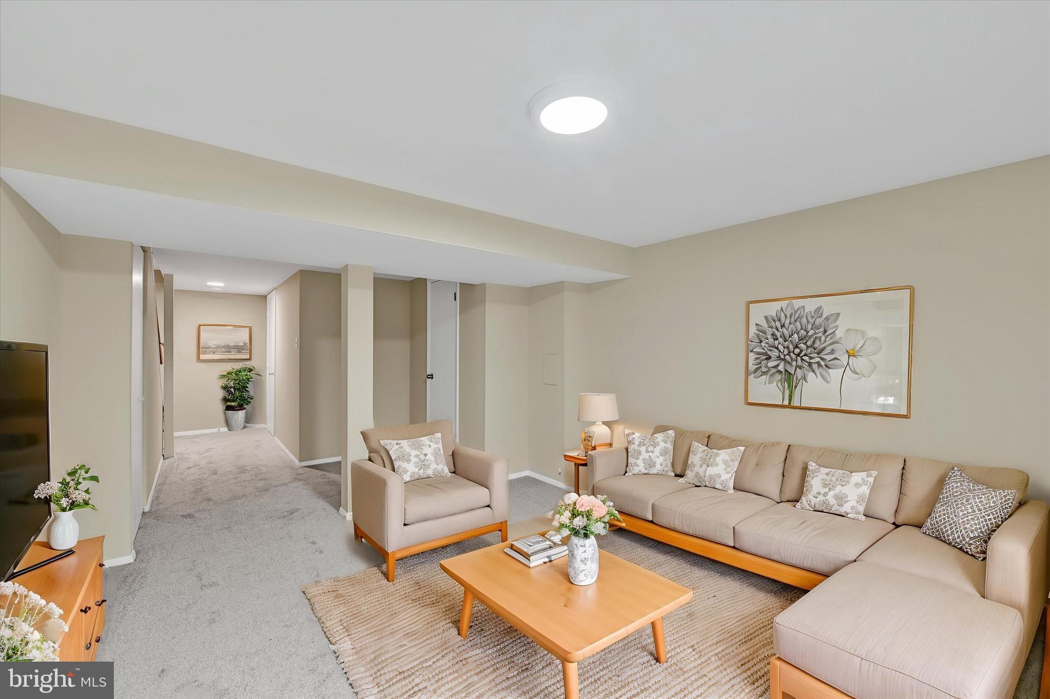 3447 Santee Road Baltimore, MD 21236 - Photo 22 of 32 a living room with furniture and a flat screen tv